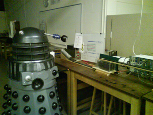 An extra-terrestrial friend checking out the advanced Mark II technology at PhysicsFest, 2009.